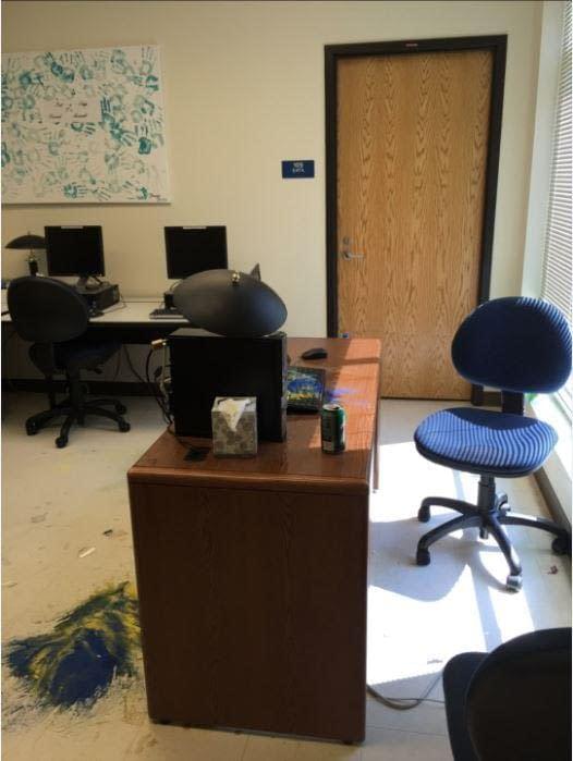 Photo courtesy of Katherine Brown.  The vandal dumped sand onto the floor and only attacked one computer.