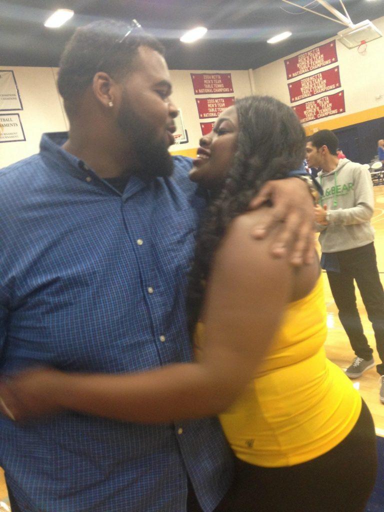 Homecoming Queen nominee Deja Chase with fiance Donald Ray Barnes after he proposed during halftime of the men's game. Photo by Dalise DeVos. 