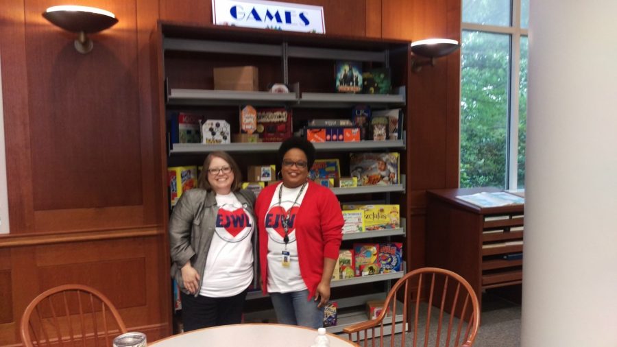 West Library director Elizabeth Howard and reference and instruction librarian Cassandra Ifie pose in front of the new game and amv shelf a stop on the National Library Week scavenger hunt.
Photo by Hannah Onder