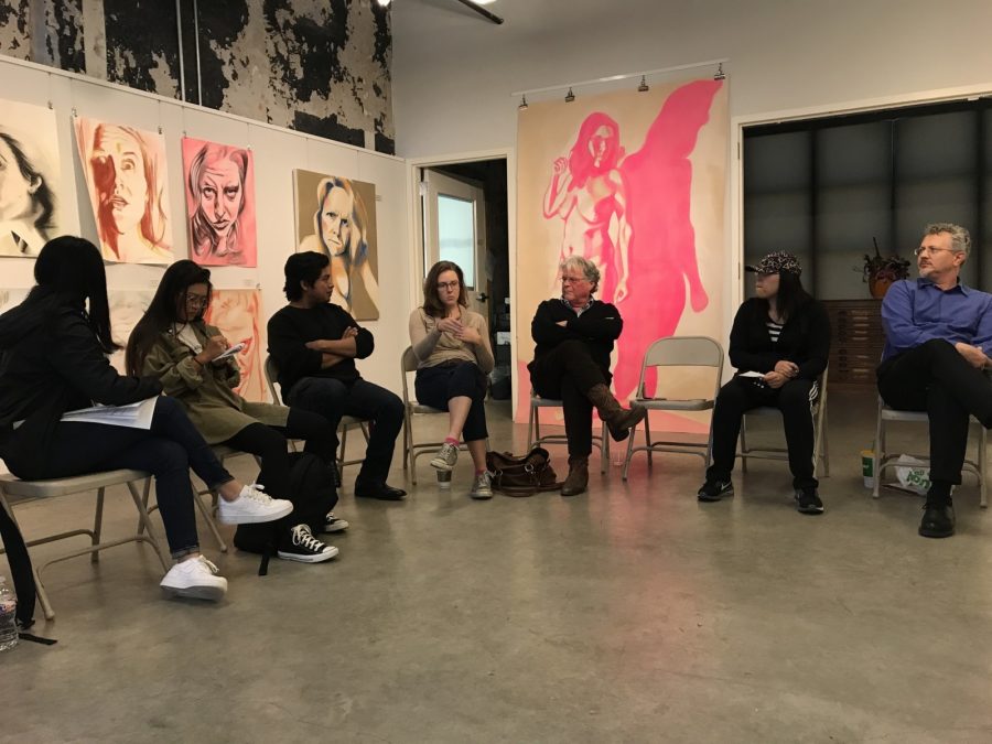 Juan Cruz (in black, arms folded) and Genevieve Armstrong (center, beige sweater) discuss their work at Tuesdays artist talk at the Bernice Coulter Templeton Art Studio. 
Photo by Hannah Lathen