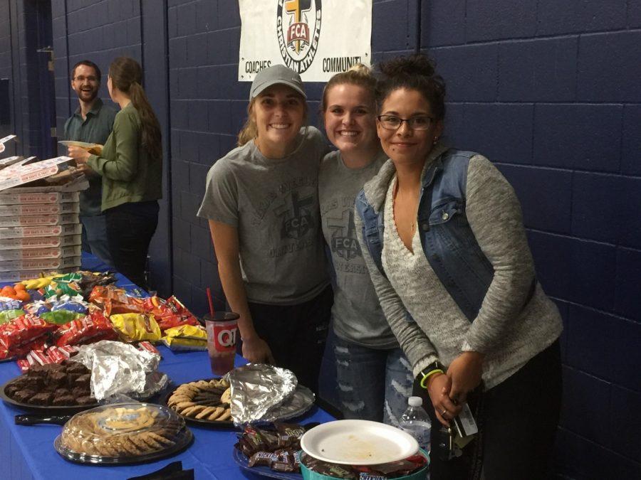 Lauren Warnet, Jacey Patton(center), Paulina Quintana passes out snacks at the FCA event on Oct. 24.
Photo by Sam Bastien