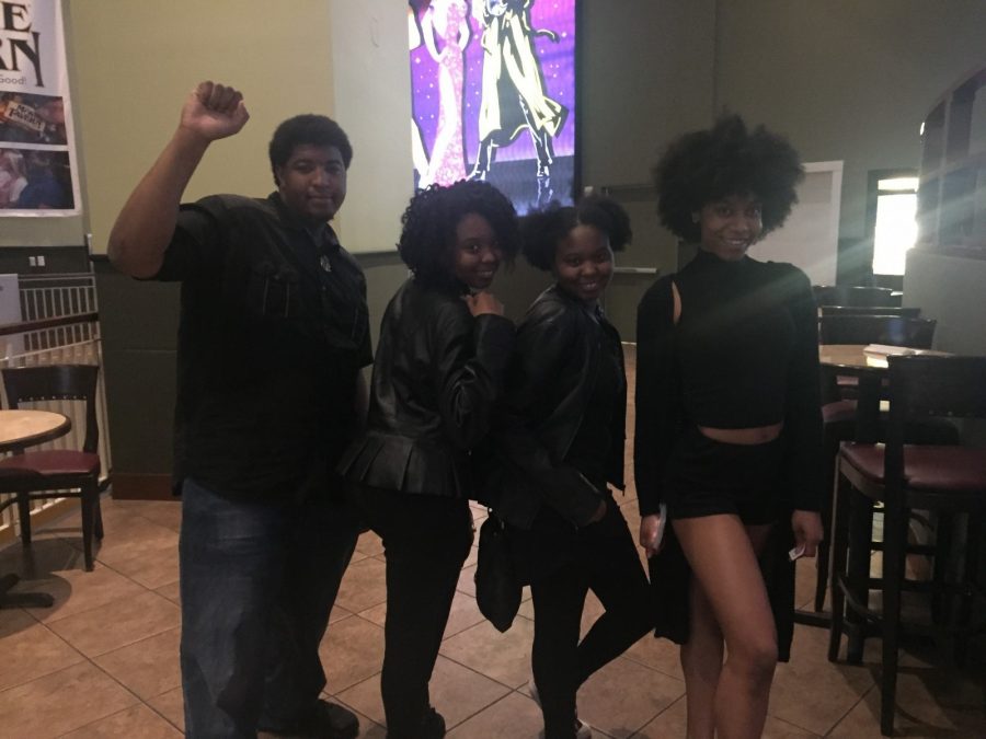 Senior psychology and Christian studies major Azeez Akande, junior criminal justice major Kiana Veasley, junior business management major Briana Veasley and freshman biology major Alexis Scott wear all black clothes to show their support for the film. 
Photo by Massaran Kromah