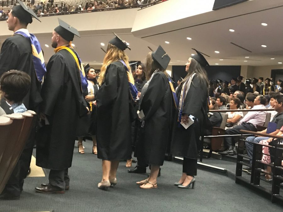 Texas Wesleyan graduates line up to take a seat before the program starts. 
Photo by Hannah Lathen