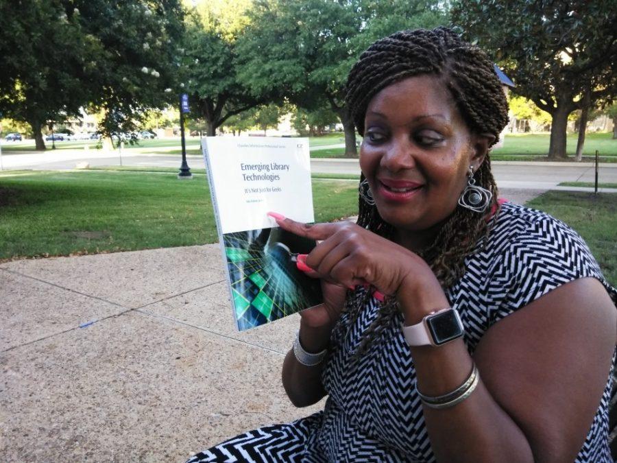Ida Joiner poses with her book “Emerging Library Technologies: It’s Not Just for Geeks!.”
Photo by Kaylia Brown