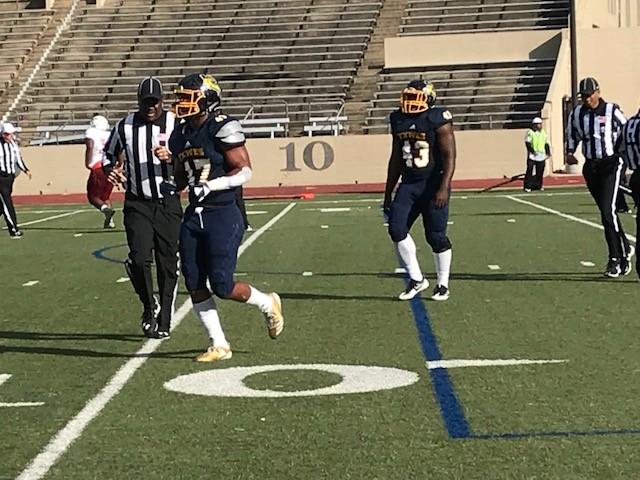 Defensive end Chijioke Iwuagu (43) and Byron Tate (47) hustle off the field after making a defensive play against Ottawa University Arizona. 
Photo by Ashton Willis