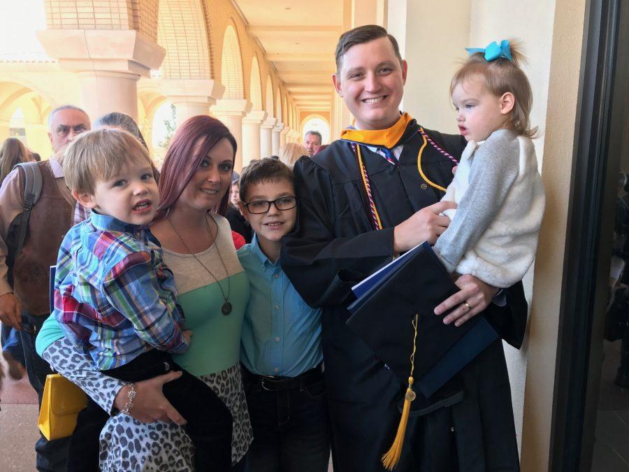 William Seltzer with his wife and kids. He graduated with his bachelor’s in computer science. 
Photo by Hannah Lathen