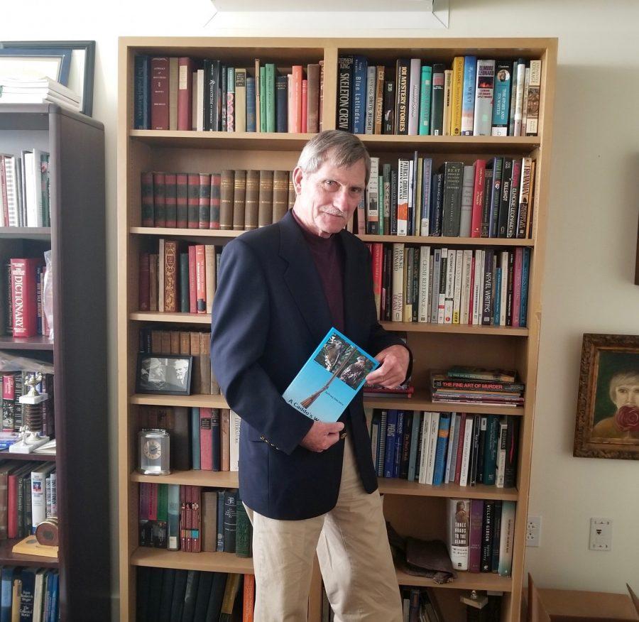 Dr. Jeffery DeLotto poses with his newly published novel in his PUMC office. 
Photo by Elena Maldonado