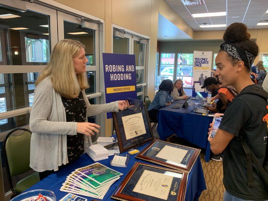 Alumni relations assistant Jeri Chipman talks with senior criminal justice major Samantha Smoot about framing options for her degree .
Photo by Chelsea Day 
