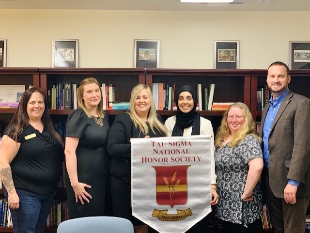 Beth Jackson, Kirsten Trudo, Jennifer Harrison, Nadine Yasin, Stacie Hill, and Dr. Chad Pevateaux (left to right) pose for a photo commemorating them as the Tau Sigma Honor Society officers and advisors for 2019-20. “Like an old restaurant might hang a sign saying, "Under New Management," we're under new leadership. As director of liberal studies, I work primarily with transfer students and was asked to take over as faculty sponsor for Tau Sigma, the national honor society to recognize outstanding transfer students. And now we have some great new members, four of whom have volunteered to take leadership roles as new officers. Their energy is contagious! Beth Jackson, academic coordinator for liberal studies, also is helping out immensely,” Pevateaux wrote. 
Photo contributed by Stacie Hill 