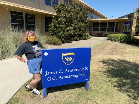 Cindy Flores poses outside James C. Armstrong & O.C. Armstrong Hall. Flores moved into O.C. Hall after a four-hour drive up from Houston with her mom, Maria, and her two brothers, Isabel and Giovanny. Photo by Hannah Onder
