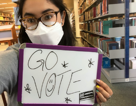 Manuela Lee holds up a “Go Vote” sign. Lee hopes students will research candidates and learn their stances on various policies. Photo courtesy of Manuela Lee.