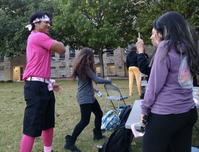 Criminal justice senior Gabriel Sanchez has fun with his friends at the SGA Block Party decked in all pink for Wednesdays Pink Out theme day.