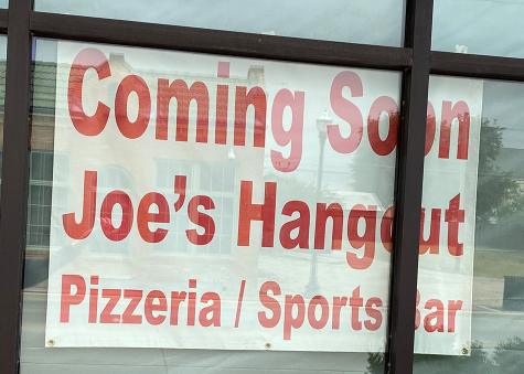 Joes Hangout displays a sign in the store-front window stating they are coming soon.