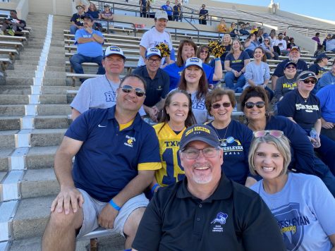 The Beard family and Bourgeois family cheer on their athletes with TX Wes Alumni Mark and Janet Stoufflet, Lou and Anne Lavely and other game spectators posing in the stands of the homecoming game.