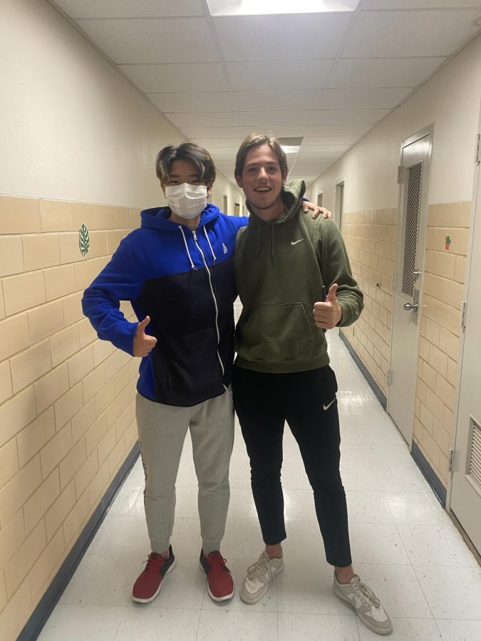 Gaku Nemoto a first year business major and Joep van Wijk a first year general business major show how some students plan to continue wearing their mask while others will go without them.