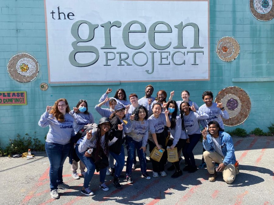 Students and The Green Project volunteer organizer pose with Rams Up signs after a full day of recycling paint. (Photo courtesy of Chatashia Brown).