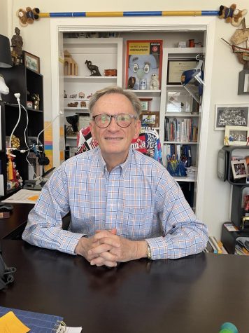 Professor Joe Brown sits in his office surrounded by his trinkets and memorabilia that make him feel more at home.
