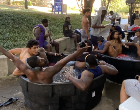 The football players sit in the ice bath every Friday morning before a game.
