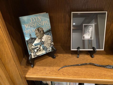 Slabach proudly displays his wife Melany Neilson’s Pulitzer Prize nominated book on his bookshelf.