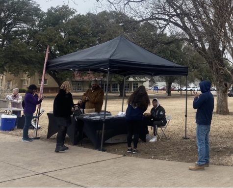 Executive Director of CoAct Jessie Herrera is tending to curious onlookers at the event he helped bring to campus.