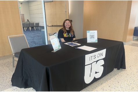 Tina Bui, president of It’s On Us, sets up to welcome students attending the event.