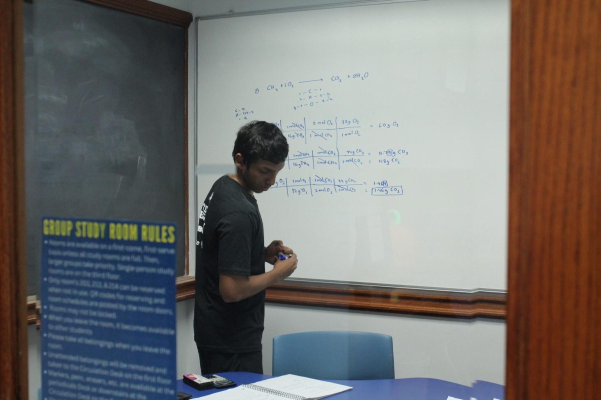 While TxWes campus has limited internet, Senu Silver, a first year biology major, is still able to complete his chemistry assignments using pen, paper and a whiteboard.