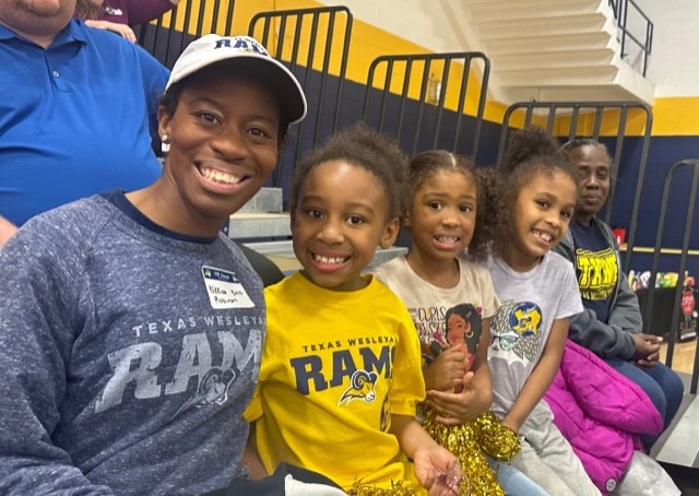 Alum Nikkina Roberson and her family cheer on the Rams at alumni day.