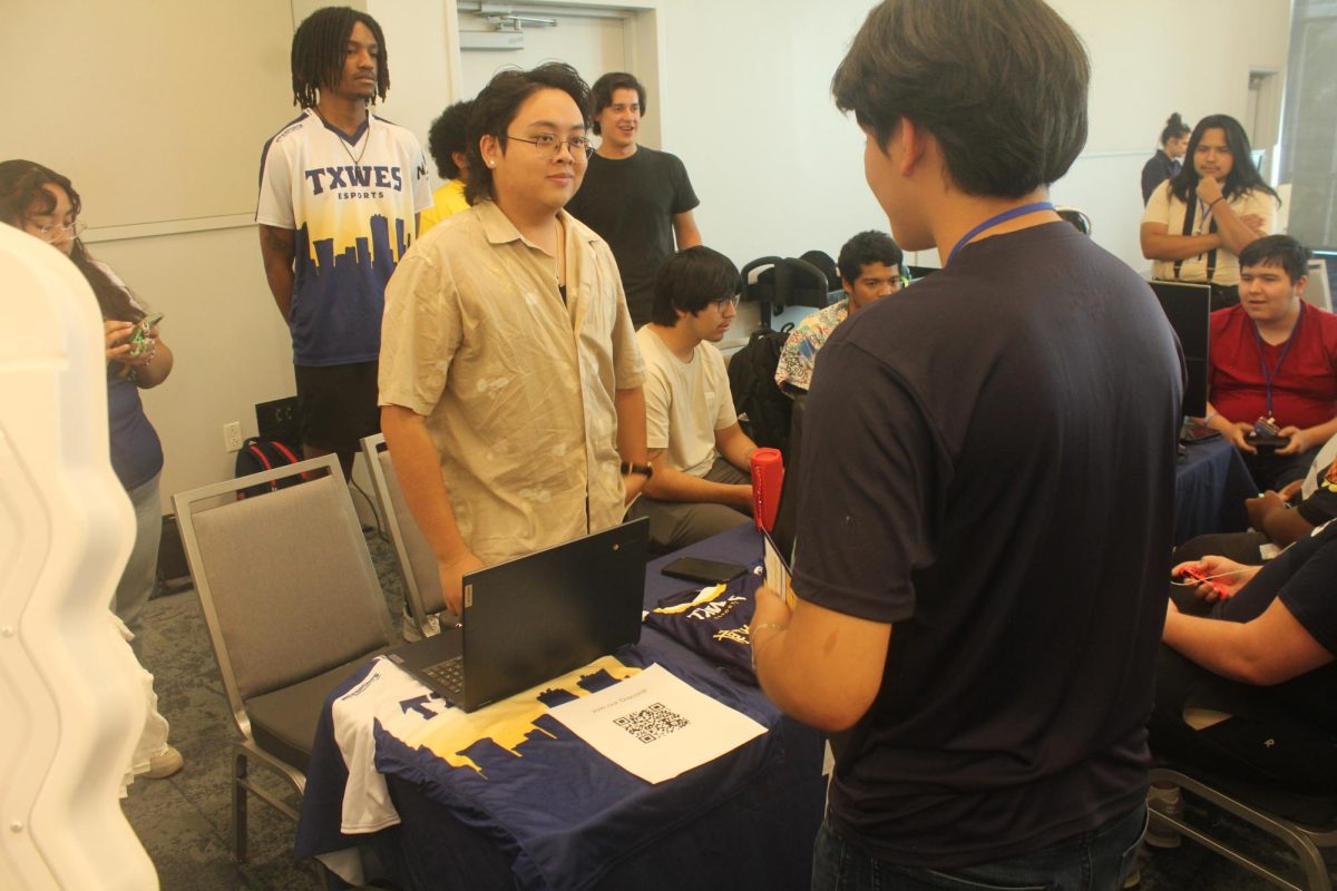 Micheal Nguyen, assistant director of esports, connects with students encouraging them to try out for the competitive Super Smash team. 