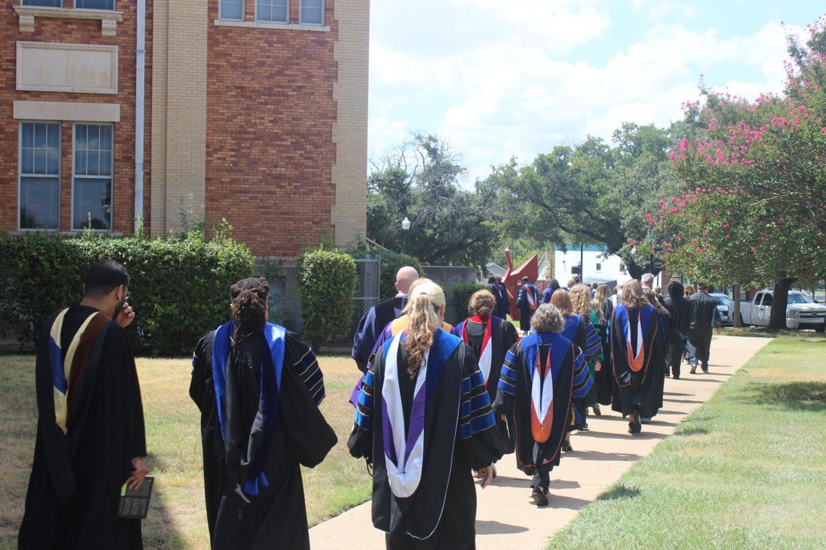 Faculty, Senior Administrators and Trustees of Texas Wesleyan file into the Nicholas Martin Hall during the procession at the start of the Convocation ceremony.  