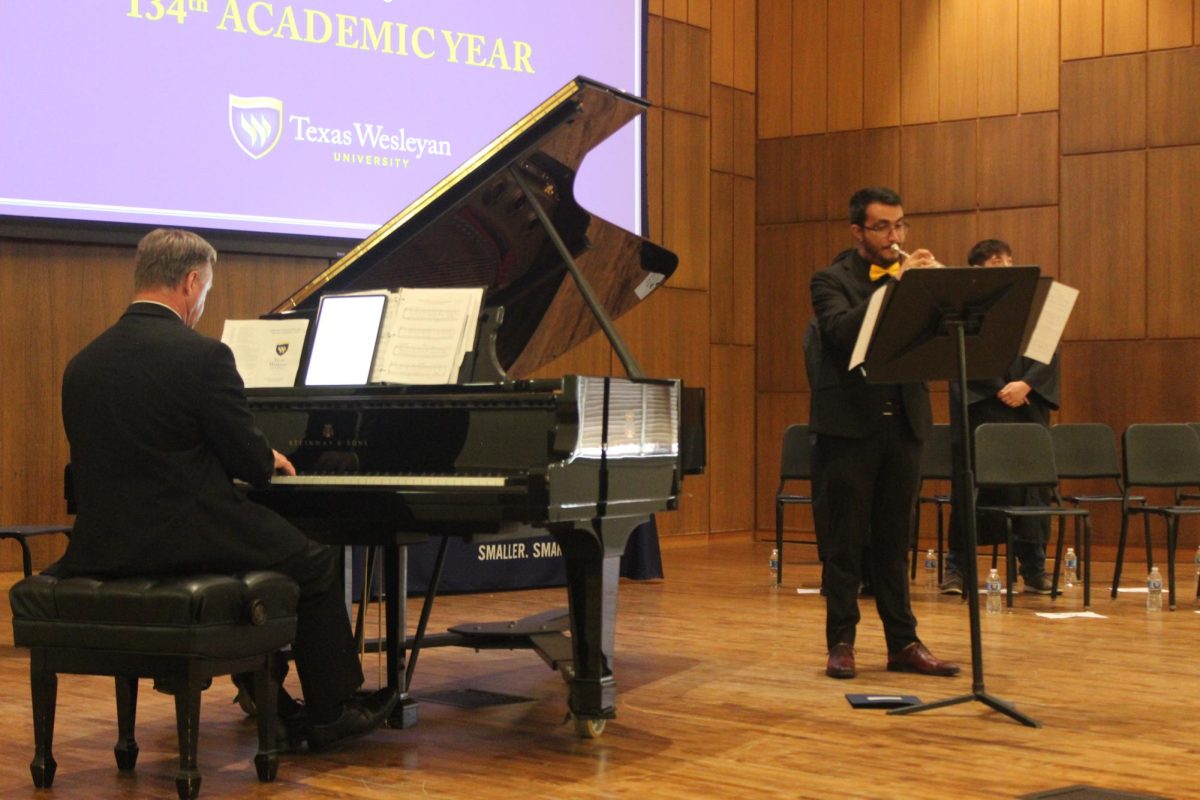 Keith Critcher performs on the keys and senior music education major Justin Talamantez plays the trumpet during the processional 