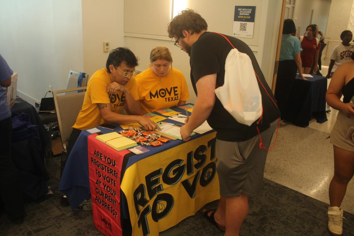 Right by the entrance, Move Texas’s table offers forms where students can register to vote. 