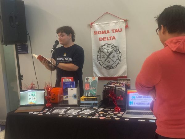 Senior English major and Vice-President of Sigma Tau Delta, Cameron Dudzinski reads a passage from a banned book aloud to the first floor of the Martin University Center. 