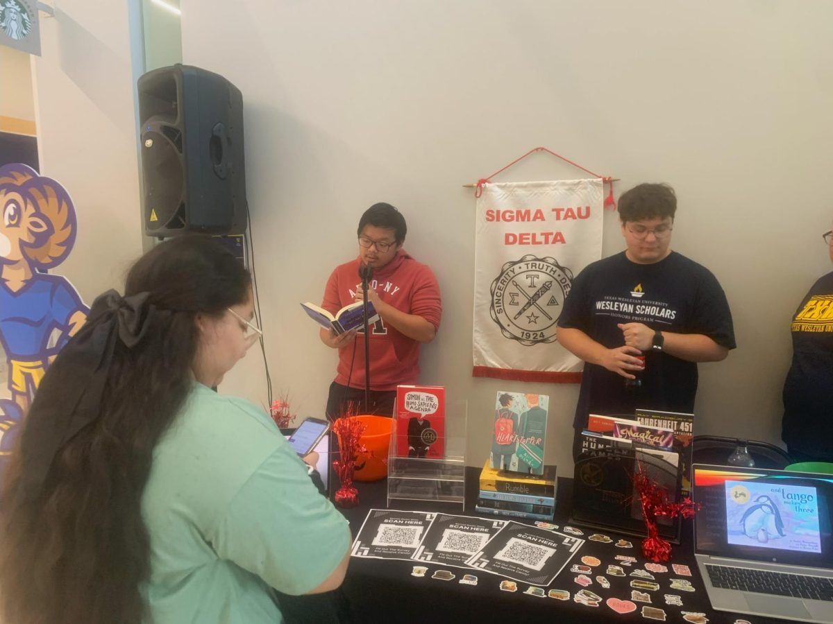 Junior marketing major Kenneth Nguyen reads a passage from ‘They Both Die at the End’ by Adam Silvera. “I find [the banning of books] outlandish,” Nguyen later said. “It limits what we can learn.” 