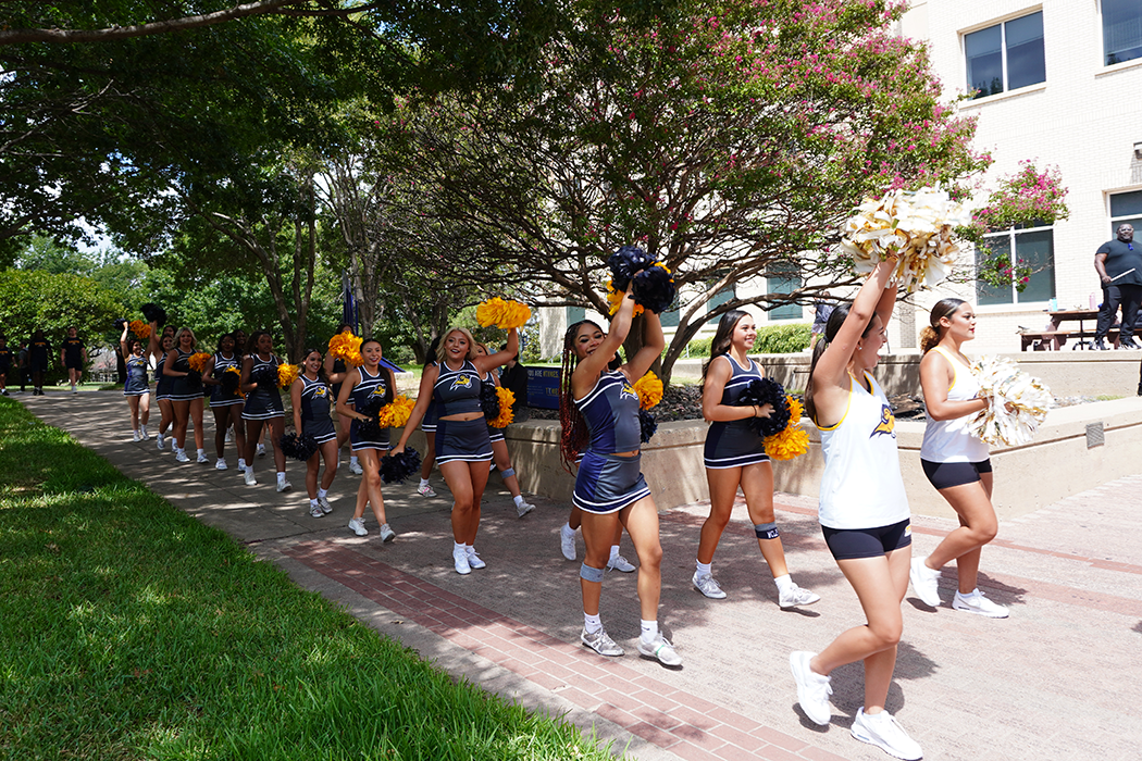 A parade led by the cheer and dance teams circles campus as people start to arrive at the pep rally.  