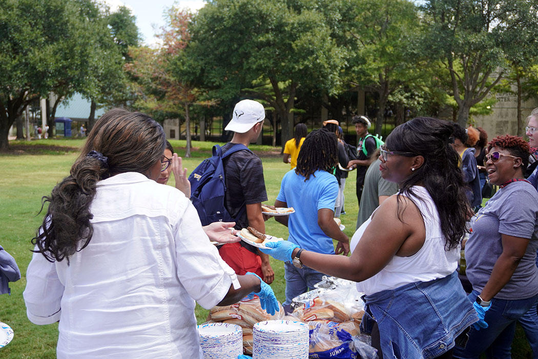 Students, staff and faculty line up for free burgers and hotdogs straight from the grill. 