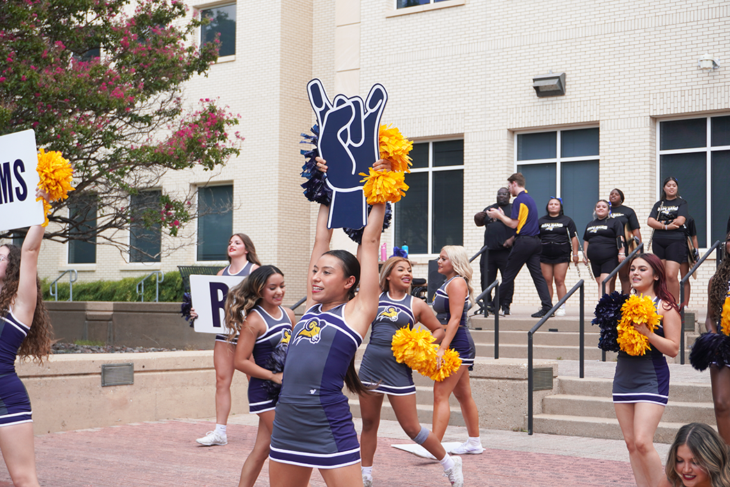 The cheer team chants as they work to get the crowd excited.   