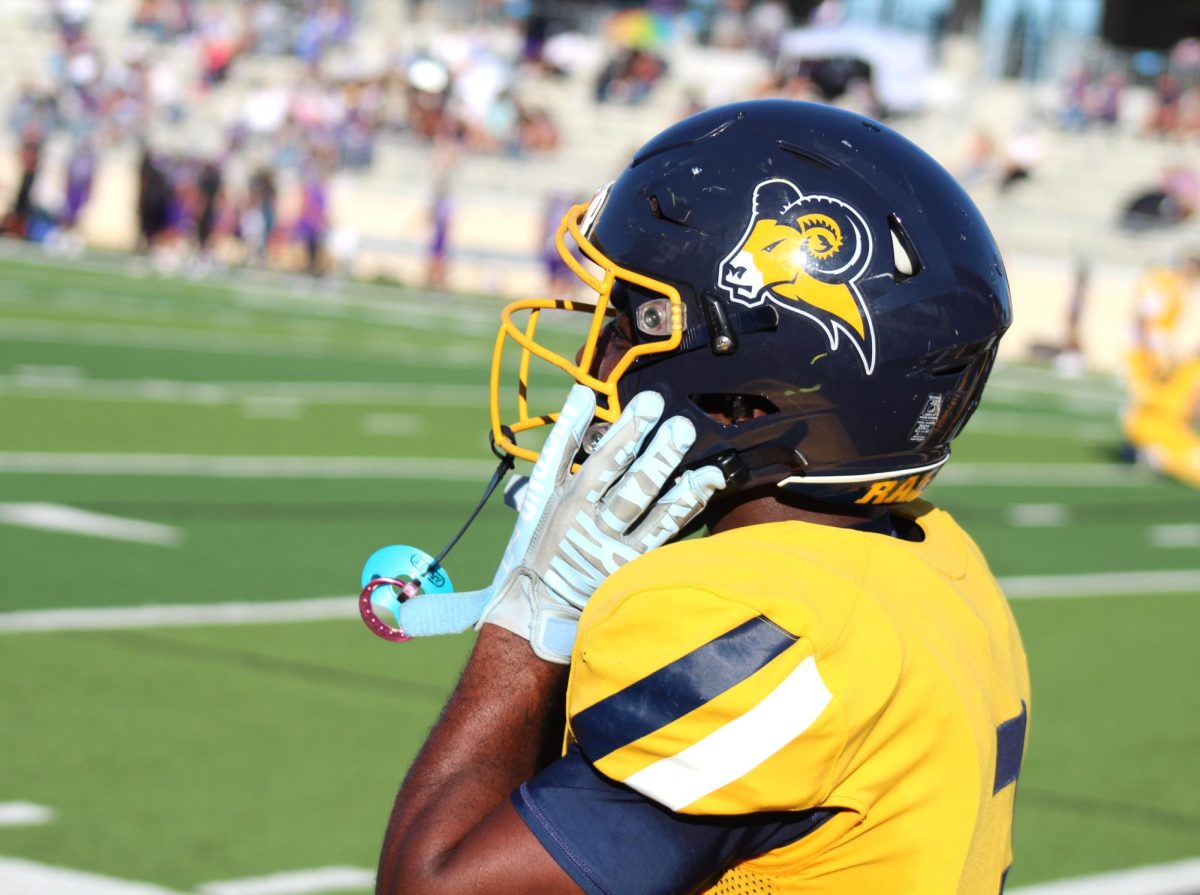 Running back Ernest Caesar takes off his helmet and heads for the sidelines after another Rams touchdown. 