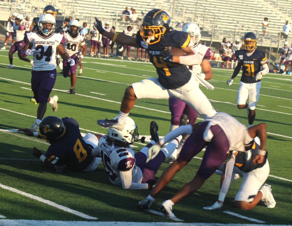 Punt returner Jaysen Price leaps over defenders as he sets the Rams offense within Buffaloe's territory. 