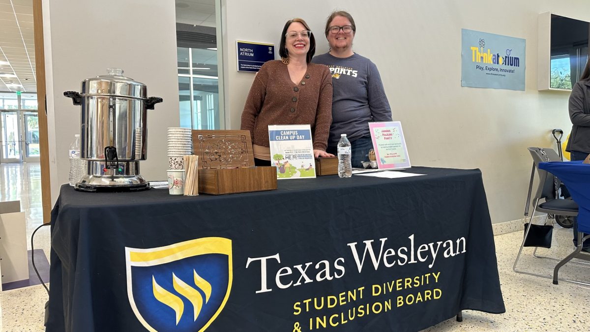 Christen Duke, a sophomore majoring in psychology, and Bertie Gardener, assistant director for student diversity & inclusion program, offer student volunteer opportunities and refreshments at their table. 