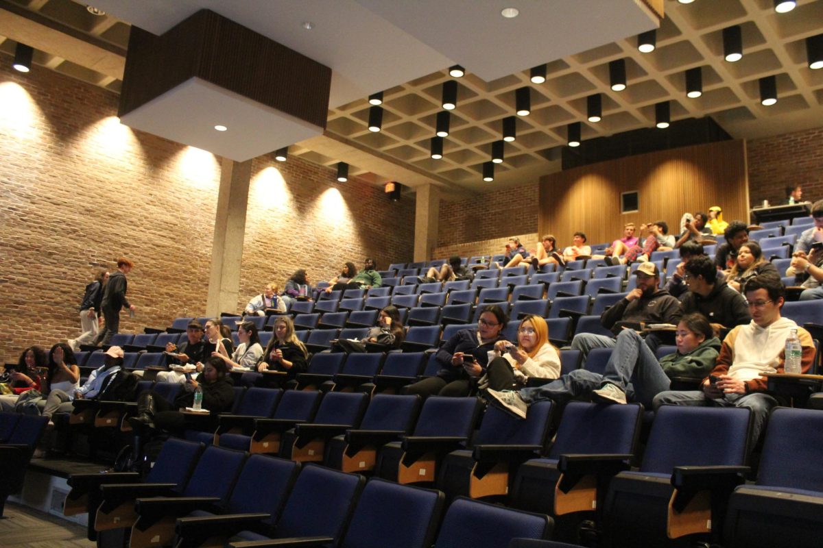 Students look on as electoral college votes are tallied up for the presidential candidates.