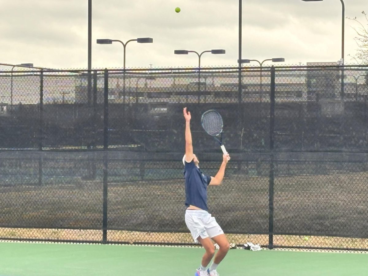 Marco Salamanca, senior double business and marketing major begins to serve in his doubles match against the Warriors.  