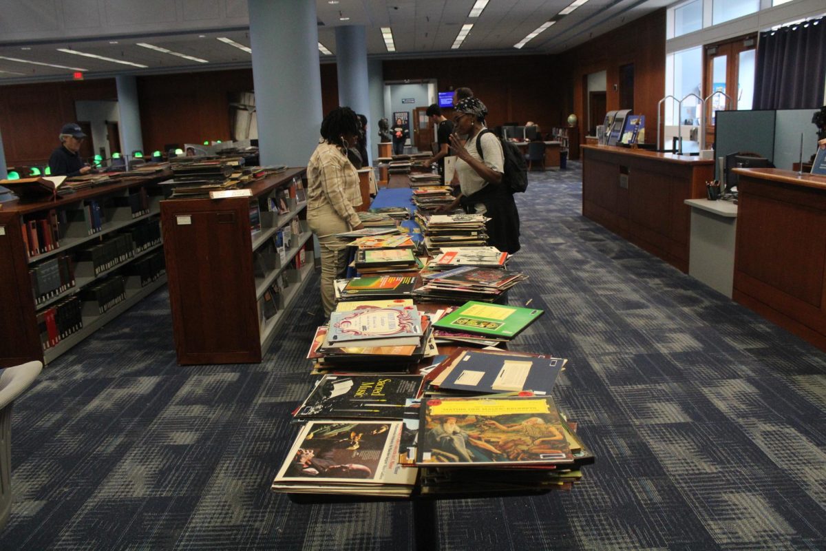 Students, faculty and staff sort through hundreds of vinyls being given away by West Library on its first floor.  