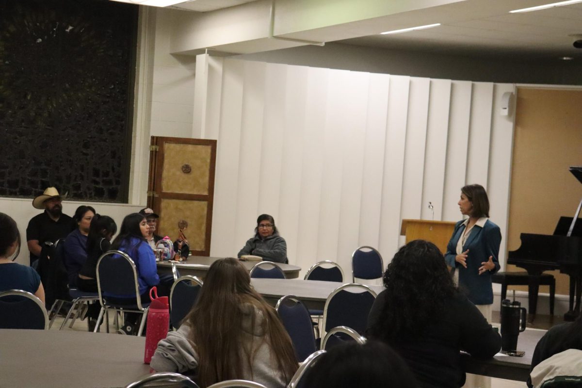 Participants listen intently to immigration lawyer Rosa Maria Berdeja as she informs them on immigration law. 