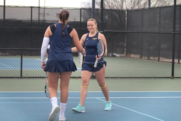 Sophomore Paulina Hudson celebrates with sophomore Kaja Brunzlow as they secure points in their doubles match against the Eagles.