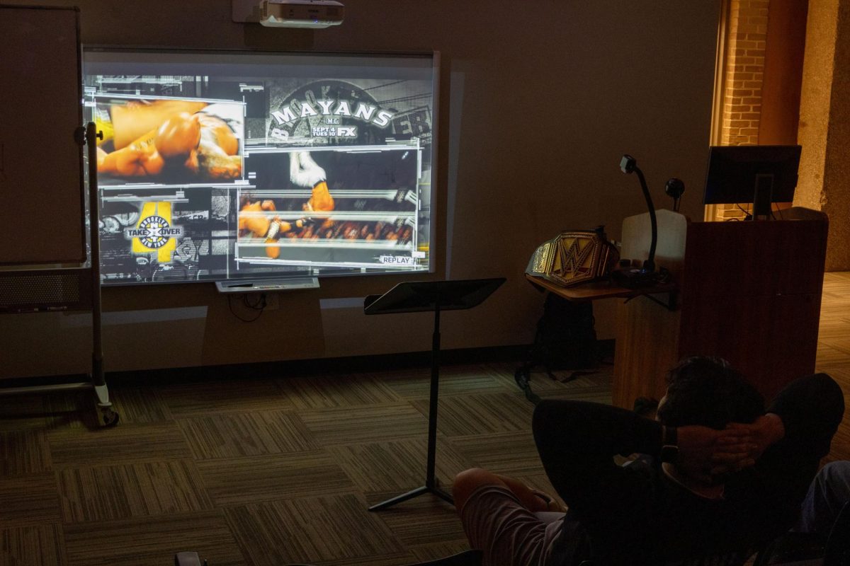 JJ Garcia and Diego Garcia watch a WWE matchup during the second meeting of RAMSLAM!, Texas Wesleyan's newest pro wrestling watch club.