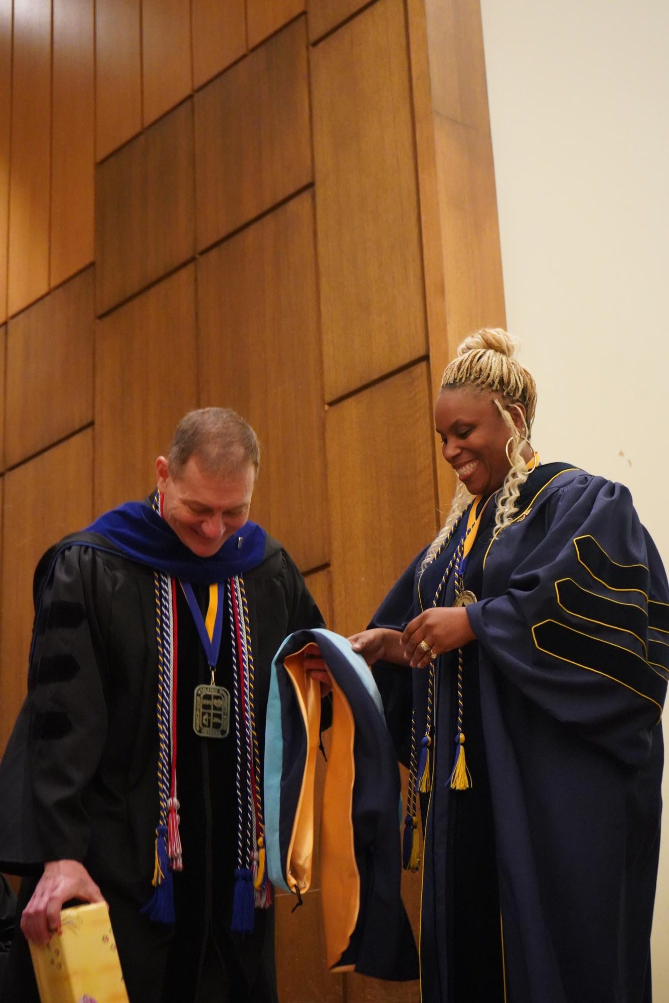 Graduating students embrace new beginnings at Robing and Hooding Ceremony